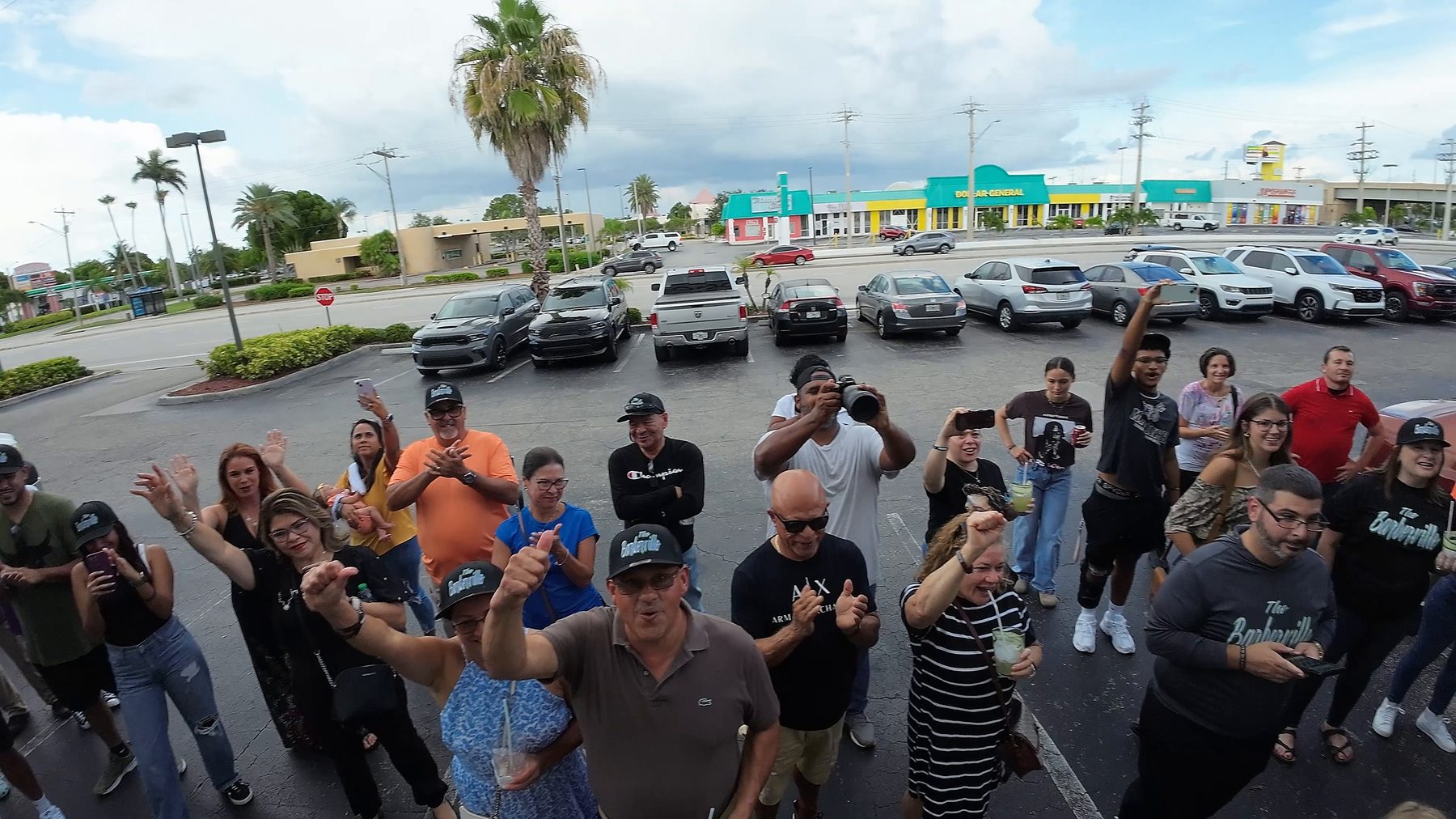Grand opening guests waving up at the drone outside Barberville