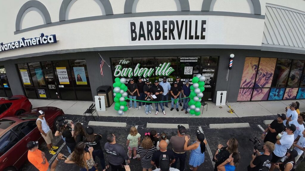 Barberville storefront with green balloons during the ribbon cutting