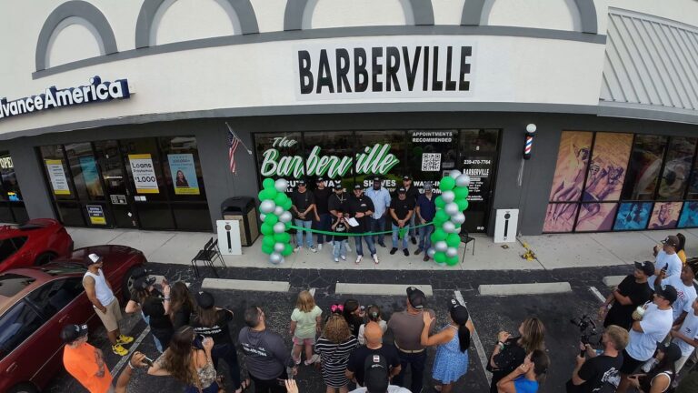 Barberville storefront with green balloons during the ribbon cutting