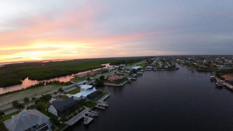 Pink sunset over Cape Coral canal homes and mangroves from the air