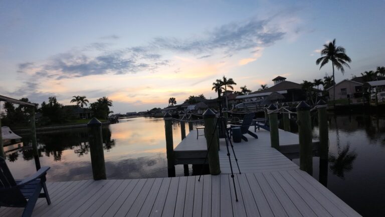 Private dock on a Cape Coral canal at sunset, shot by drone