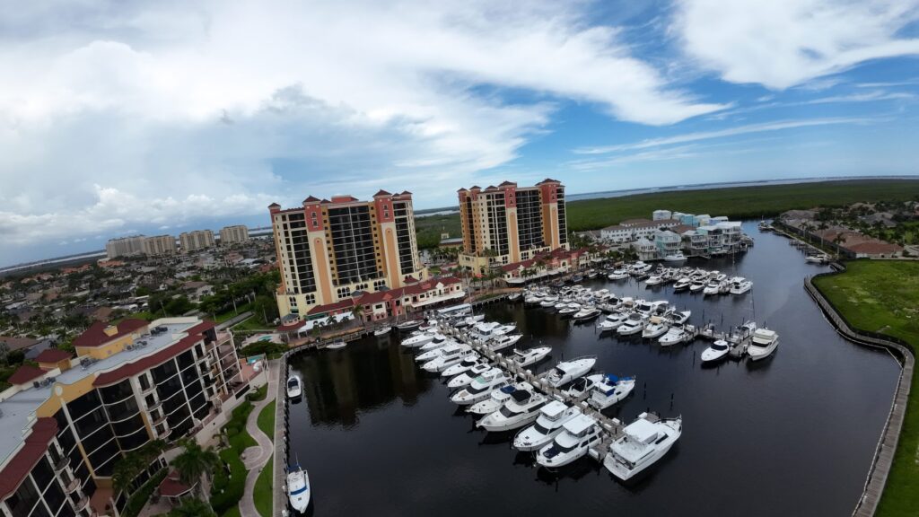Drone photo of yachts docked at Cape Harbour beside high-rise condos, Cape Coral
