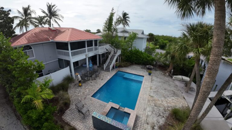 Elevated drone photo of a Fort Myers Beach home with pool and patio