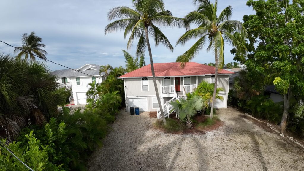 Drone view of a Fort Myers Beach home roof and lot for a property inspection