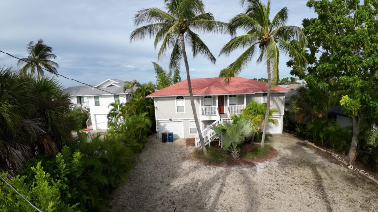 Drone view of a Fort Myers Beach home roof and lot for a property inspection