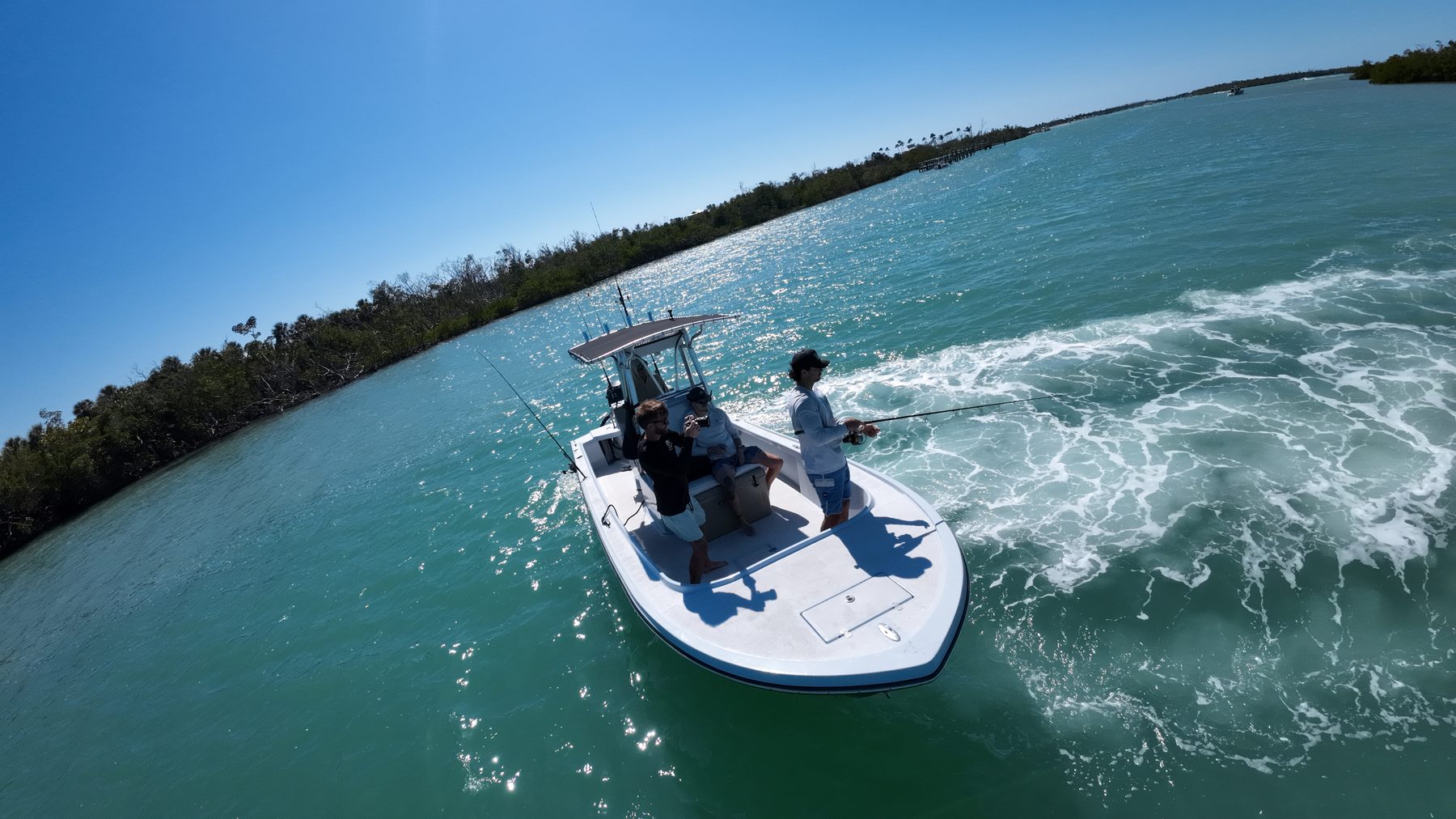 FPV drone chasing a charter boat through its spray