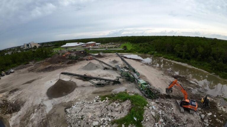 Aerial of a South Florida Bobcat material recycling site with conveyors and excavator